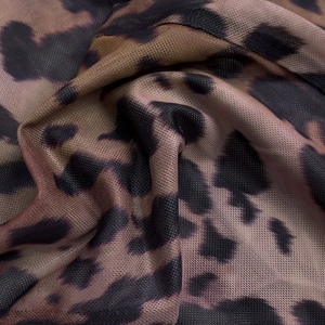 Close-up of leopard print mesh fabric with fine net texture and detailed brown patterns
