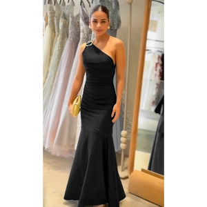 Detail of elegant black one-shoulder evening gown with shoulder buckle and waist ruching