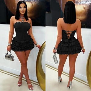 Front and back view of black corset tube mini dress with lace-up back and ruffled skirt
