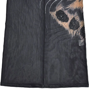 Detail view of black mesh fabric with animal print and sparkling rhinestone accents