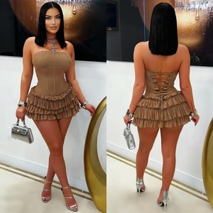 Detail of a brown corset dress featuring tiered ruffles and a lace-up back design