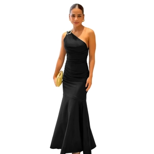 Detail of elegant black one-shoulder fishtail dress with silver buckle and pleated waist