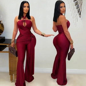 Detail view of the halter neck hollow design and burgundy satin fabric on wide leg jumpsuit