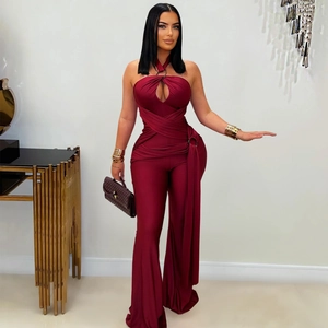 Detail of burgundy halter jumpsuit featuring waist cutout and metallic ring embellishment