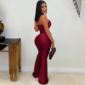 Rear view of sleek wine red backless jumpsuit with halter neck and flared leg pants