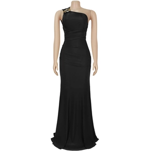 Detail of elegant black one-shoulder dress with gold chain links and pleated fabric
