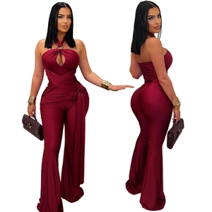 Detail of burgundy halter neck jumpsuit with metal ring and waist cut-out design