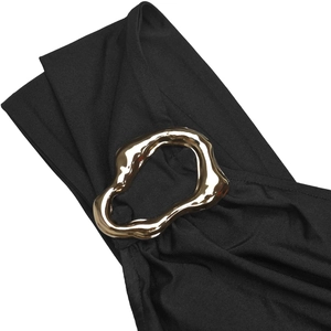 Detail of elegant black knit fabric with a wavy golden metal ring ornament detail