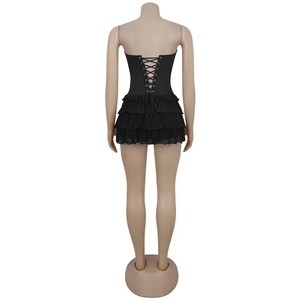Detail of black strapless mini dress with cross lace-up back and ruffled chiffon hemline