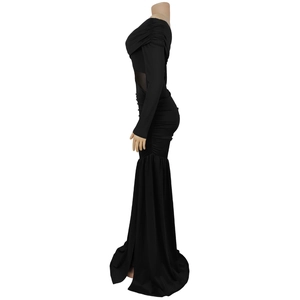 Detail of sheer black mesh waist insert and side ruching on a bodycon dress