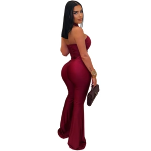 Detail view of burgundy halter neck jumpsuit featuring an open back and flare leg style