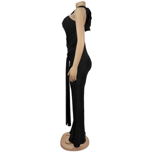 Detail view of the black evening dress showing side ruching and long hanging fabric tie
