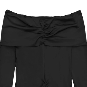Détail de la robe en maille noire à épaules dénudées avec décolleté froncé et manches