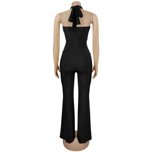Detailed back view of a black halter neck jumpsuit with an elegant bow tie design