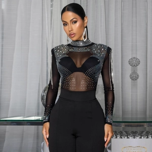 Detail of sheer black mesh bodysuit featuring rhinestone embellishments and fringe sleeves