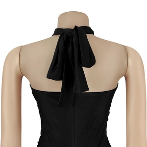 Detail view of black halter neck jumpsuit back featuring a stylish tie-up bow closure
