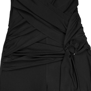 Detailed view of black halter jumpsuit featuring side ruching and knotted waist design