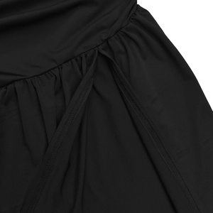 Close-up of ruched black knit fabric showing premium overlock stitching and slit details