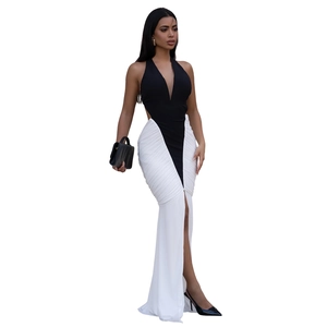 Detail of elegant backless V-neck dress with black halter top and white slit fishtail skirt