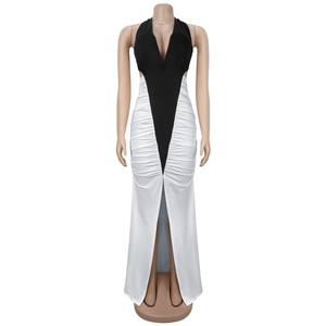 Detail of elegant black and white V-neck dress with ruched fabric and high front slit