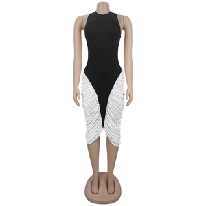 Detail view of the black and white halter neck dress with intricate side pleats and ruffles