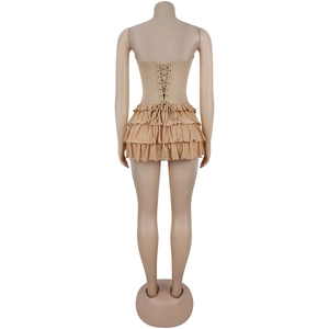 Close-up of the adjustable lace-up corset back and tiered ruffle layers on a beige dress
