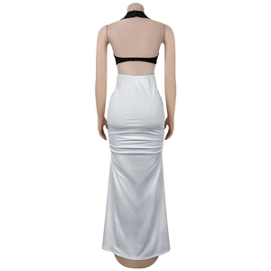 Detail of cross-back straps and ruching on black and white backless bodycon dress