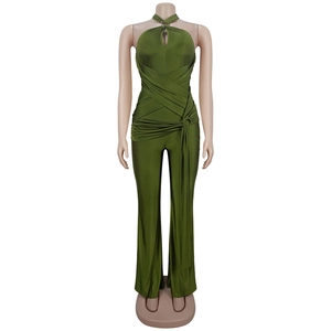 Macro detail of olive green halter neck jumpsuit with keyhole cutout and pleated waist