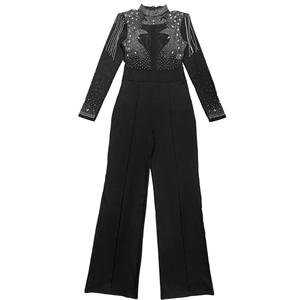 Detail of sheer mesh jumpsuit featuring sparkling rhinestones and shoulder tassel accents