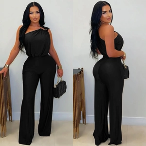 Close-up of black one-shoulder jumpsuit with pleated waist and wide-leg design