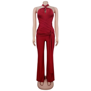 Detail of burgundy halter neck jumpsuit with cutout design and waist ring buckle