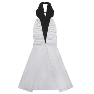 Detail of elegant two-tone dress featuring a black halter neck cutout and white draped skirt