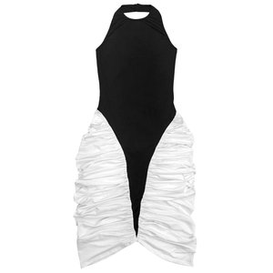 Detail of the black halter dress featuring elegant white side ruching and patchwork