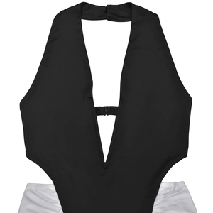 Detail view of monochrome cutout bodysuit with deep V-neck and contrasting side panels