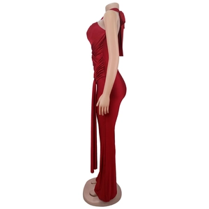 Detail view of deep red sleeveless evening jumpsuit with side pleats and elegant streamers