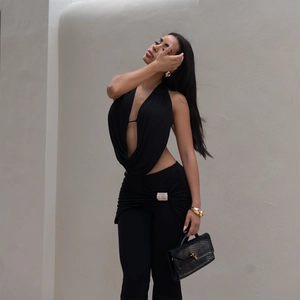 Detail of backless halter top and trousers with rhinestone buckle decoration