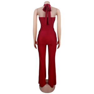 Detail of burgundy backless halter jumpsuit featuring flared legs and elastic slim fit