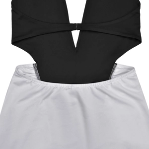 Close-up of black and white color block bodysuit with silver metal buckle detail