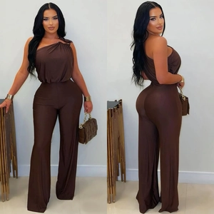 Detail view of coffee brown one-shoulder jumpsuit with golden ring buckle decoration