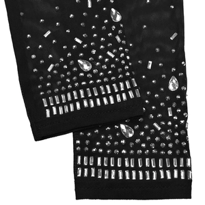 Detail of black sheer mesh fabric with sparkling silver rhinestones and fine edge stitching