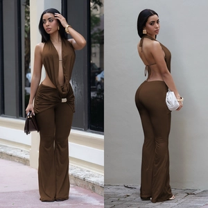 Detail view of brown backless halter top and flared pants with diamond buckle