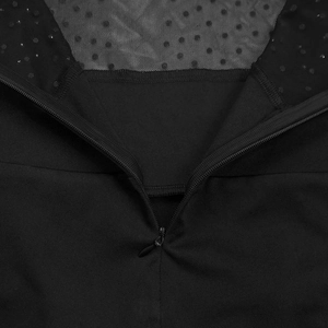 Detail of invisible teardrop zipper on black mesh bodysuit with polka dot sequins