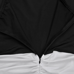 Close-up of invisible back zipper and gathered pleats on the black and white bodycon dress
