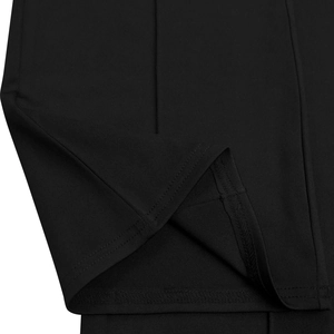 Close-up of high-quality double-needle stitching and raw fabric edge on black jumpsuit