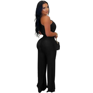 Detail of black one-shoulder jumpsuit featuring a slim-fit waist and wide-leg trousers cut