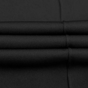 Detailed macro shot of premium black knitted fabric showing texture and soft drape