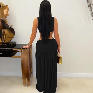 Back view of elegant two-piece black set featuring sleeveless crop top and high waist slit skirt