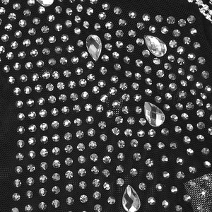 Detail of sheer black mesh fabric with sparkling rhinestones and teardrop crystals