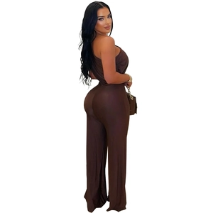 Detail view of brown halter neck backless wide-leg jumpsuit with metallic accessories