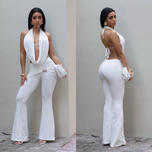 Detail of white halter neck backless top and flared trousers with metallic side buckle